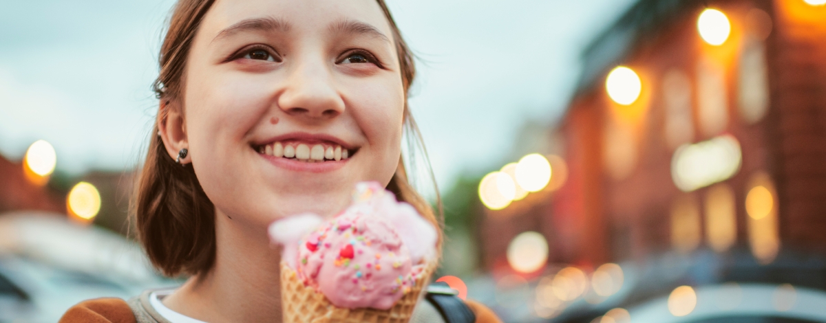 Teen girl holding ice cream cone