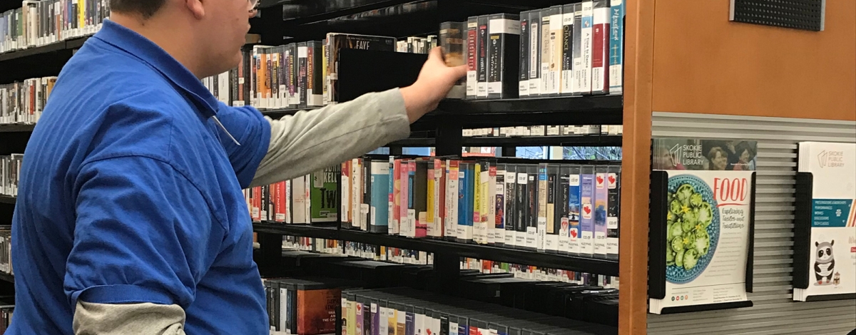 Transition student Nathan sorting library books