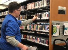 Transition student Nathan sorting library books